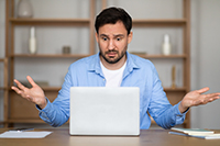 Confused man staring at bad Ocean County web design